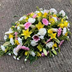 Pink and yellow casket spray